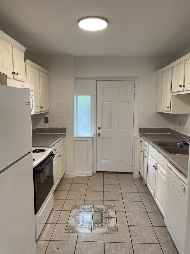 Spacious kitchen off of living room with exit to private yard - 2000 Central Ave