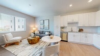 Located on Manatee Ave W in Bradenton, Florida, this 1-bedroom, 1-bathroom residence offers a clean, modern aesthetic with a well-planned open-concept layout. Light wood-style flooring flows throughout, unifying the main living areas and creating a bright, cohesive feel.

The kitchen is a standout feature, equipped with white shaker cabinetry extending to the ceiling, granite countertops, a white subway tile backsplash, and a full suite of stainless steel appliances including a dishwasher, range, microwave, and refrigerator. A round dining area adjacent to the kitchen provides an inviting space for meals.

The living room receives generous natural light through large windows fitted with horizontal blinds, and offers comfortable space for relaxing and entertaining. A hallway connects the living areas to the private bedroom, which features its own large window with outdoor views, light wood flooring, and a walk-in closet outfitted with wire shelving for ample storage.

The bathroom is finished with marble-look tile flooring and wall surround, a white vanity with granite countertop, and a full tub-shower combination. Soft, neutral tones throughout the space contribute to a calm and contemporary ambiance well-suited to modern living in coastal Florida.