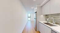 This 400 square foot studio apartment in Los Angeles offers a modern and efficient living space. The open-concept design combines the kitchen, living room, and sleeping area into one cohesive space, maximizing functionality. The apartment features sleek hardwood flooring throughout, creating a warm and inviting atmosphere.

The kitchen boasts contemporary white cabinetry, stainless steel appliances, and a stylish tiled backsplash. It's equipped with a gas range, dishwasher, and ample counter space for meal preparation. The living area is bathed in natural light from large windows, providing a bright and airy feel to the space.

The bathroom is well-appointed with a glass-enclosed shower, modern fixtures, and clean lines. Recessed lighting throughout the apartment adds to the contemporary ambiance. A notable feature is the apartment's clever use of space, with built-in storage solutions to maximize the compact floor plan.

The studio's layout is designed for easy navigation and comfortable living, despite its modest size. Its location on Santa Monica Boulevard places residents in the heart of Los Angeles, offering convenience and urban amenities. This apartment is ideal for those seeking a minimalist lifestyle without compromising on style or location.