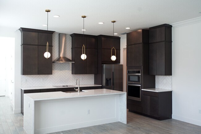 Upgraded kitchen with quartz waterfall island - 13222 Bromborough Dr