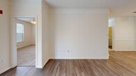 This well-designed apartment offers 1010 square feet of comfortable living space on a single floor. The open-concept layout seamlessly integrates the living room and kitchen, creating an inviting atmosphere for relaxation and entertainment. The kitchen boasts vibrant honey-colored cabinetry, contrasting beautifully with white appliances and dark countertops. Track lighting adds a modern touch, while a breakfast bar provides additional seating.

The apartment features two bedrooms, including a spacious 160 square foot primary bedroom, both equipped with ceiling fans for comfort. Two full bathrooms, one with a tiled shower/tub combination, offer convenience and privacy. The unit includes an in-unit laundry area with a washer and dryer, enhancing everyday living.

Large windows throughout allow ample natural light, while a private balcony accessible through sliding glass doors extends the living space outdoors. The flooring varies, with carpet in bedrooms, wood-look laminate in main living areas, and tile in the kitchen and bathrooms. Crown molding and neutral wall colors contribute to the apartment's polished appearance, making it a versatile canvas for various decorating styles.