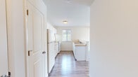 Located at 56 Hampshire Ln in Gibsonia, PA, this one-bedroom, one-bathroom unit offers a thoughtfully organized single-floor layout designed for efficient, comfortable living. Light-toned luxury vinyl plank flooring runs consistently throughout the space, lending a clean, cohesive aesthetic to every room.

The kitchen is a functional galley-style space featuring white cabinetry with ample upper and lower storage, light laminate countertops, a double-basin sink, and white appliances including a range and refrigerator. A window above the countertop provides natural light and an outdoor view. A peninsula counter separates the kitchen from the adjoining living area, creating an open and connected feel between both spaces.

The bedroom is a well-proportioned room with a window that admits natural light, a wall-mounted HVAC unit for climate control, and a ceiling fan with a light fixture overhead — a practical and comfortable combination.

The bathroom is straightforward and clean, featuring a full-size soaking tub with a showerhead and chrome fixtures set against bright white surrounds.

Throughout the unit, neutral wall tones and consistent flooring create a bright, move-in-ready atmosphere well-suited to everyday living in the Gibsonia area.