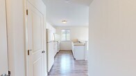 Located at 56 Hampshire Ln in Gibsonia, PA, this one-bedroom, one-bathroom unit offers a thoughtfully organized single-floor layout designed for efficient, comfortable living. Light-toned luxury vinyl plank flooring runs consistently throughout the space, lending a clean, cohesive aesthetic to every room.

The kitchen is a functional galley-style space featuring white cabinetry with ample upper and lower storage, light laminate countertops, a double-basin sink, and white appliances including a range and refrigerator. A window above the countertop provides natural light and an outdoor view. A peninsula counter separates the kitchen from the adjoining living area, creating an open and connected feel between both spaces.

The bedroom is a well-proportioned room with a window that admits natural light, a wall-mounted HVAC unit for climate control, and a ceiling fan with a light fixture overhead — a practical and comfortable combination.

The bathroom is straightforward and clean, featuring a full-size soaking tub with a showerhead and chrome fixtures set against bright white surrounds.

Throughout the unit, neutral wall tones and consistent flooring create a bright, move-in-ready atmosphere well-suited to everyday living in the Gibsonia area.