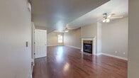 This two-story home in Little Rock, Arkansas offers a well-designed layout across two levels, combining functional living spaces with attractive finishes throughout. The main living area is generously proportioned, showcasing rich, dark hardwood floors that extend throughout the primary living spaces. A classic fireplace with a white surround serves as a focal point, while ceiling fans provide comfort and airflow. Natural light enters through multiple windows fitted with blinds, and a carpeted staircase connects the two floors.

The kitchen is well-equipped, featuring white cabinetry with under-cabinet lighting, granite countertops, stainless steel appliances including a gas range, built-in microwave, and a French door refrigerator. A peninsula with a sink adds additional prep space and casual seating potential.

The bedrooms feature wood-look flooring, ceiling fans, and windows that bring in natural light. One bedroom includes dual closets, offering generous storage. The bathrooms are finished with light tile flooring, white cabinetry, granite countertops, and well-lit vanity mirrors. A dedicated laundry area with upper shelving and utility hookups adds further practicality to this well-rounded home.