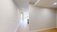 Located at 118 Elm St in Westfield, NJ, this well-designed 2-bedroom, 2-bathroom residence offers a thoughtful layout across a single floor. Light hardwood flooring flows throughout, creating a bright and cohesive aesthetic.

The open-concept kitchen and living area serves as the heart of the home. The kitchen is equipped with white shaker-style cabinetry accented by gold hardware, a subway tile backsplash, stainless steel appliances including a gas range and French door refrigerator, and a large center island with a quartz countertop and undermount sink. Stylish pendant lighting with gold accents adds a refined touch. The spacious living area opens to a private balcony through floor-to-ceiling sliding glass doors, inviting abundant natural light and outdoor views.

Both bedrooms are generously proportioned, featuring large windows that bring in natural light and views of the surrounding neighborhood. The primary bedroom includes dedicated closet space with built-in shelving for organized storage.

The two bathrooms are finished with warm wood vanities, white quartz countertops, brushed nickel fixtures, and elegant marble-style tile flooring. The primary bath features a double-sink vanity with a large mirror and wall sconces. A dedicated laundry area and a connecting hallway round out the functional layout of this modern residence.