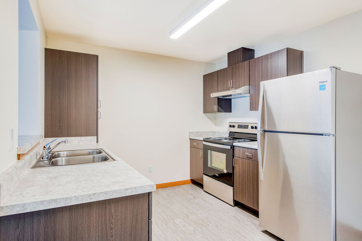 Kitchen with Stainless Steel Appliances - The Orchard Apartments