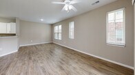 Located at 100 Big River Dr in Lake Saint Louis, Missouri, this one-bedroom, one-bathroom unit offers a well-designed, single-floor layout that maximizes comfort and functionality. The open-concept kitchen and living area forms the heart of the home, featuring light wood-look flooring, warm neutral-toned walls, and a ceiling fan overhead. The kitchen is outfitted with crisp white shaker-style cabinetry, granite countertops, stainless steel appliances including a refrigerator, range, and over-the-range microwave, and a peninsula with a sink that overlooks the living space. The living room receives natural light through multiple windows and a sliding glass door that opens to an outdoor view of the grounds. The spacious primary bedroom is carpeted for warmth and comfort, equipped with a ceiling fan and a window with blinds that allows natural light. The full bathroom features a walk-in shower with built-in shelving and grab bar support. A dedicated in-unit laundry area houses a full-size washer and dryer with overhead wire shelving for additional storage. Clean finishes, consistent neutral tones, and practical features throughout create a cohesive and move-in-ready living environment.