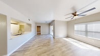Located at 9620 W Russell Rd in Las Vegas, NV, this 2-bedroom, 3-bathroom residence offers a thoughtfully designed single-floor layout that maximizes both comfort and functionality. The open-concept living area is finished with light wood-look flooring, neutral-toned walls, and ceiling fans, creating a bright and airy atmosphere. Natural light streams in through a sliding glass door that leads to an outdoor area, complemented by a large window that enhances the sense of openness. The kitchen features white cabinetry, gray subway tile backsplash, white countertops, and stainless steel appliances, including a refrigerator, range, and over-the-range microwave, seamlessly connected to the living space via a pass-through. Both bedrooms are carpeted and include ceiling fans and dedicated closets with wire shelving. The primary bedroom offers direct access to its own bathroom and a walk-in closet. The bathrooms are clean and functional, with one featuring a full tub-shower combination and wood-look tile flooring. Additional conveniences include a dedicated laundry area, a hallway connecting the rooms, and two closets providing ample storage throughout this well-appointed Las Vegas residence.