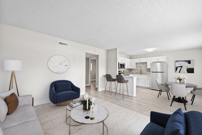 Relax in a bright and open living space designed for modern comfort - The Lynx Townhomes and Apartments