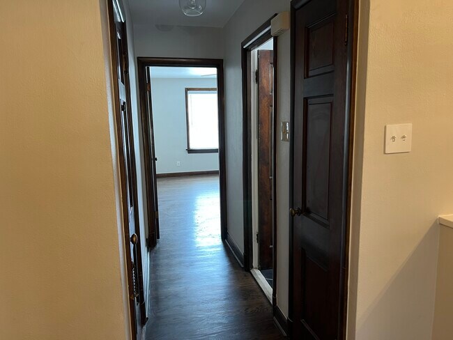 Hallway leading to bedroom. Backdoor which goes to laundry room with storage and additional closet - 5824 Nottingham Ave