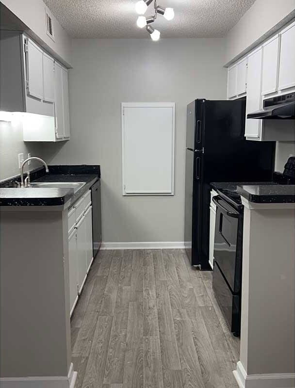 Elevate your lifestyle at Riverwood Park Apartments, where modern design meets comfort. Enjoy sleek cabinetry and upgraded appliances in a spacious kitchen perfect for culinary creations. Schedule your tour today and find your ideal home. - Riverwood Park Apartments