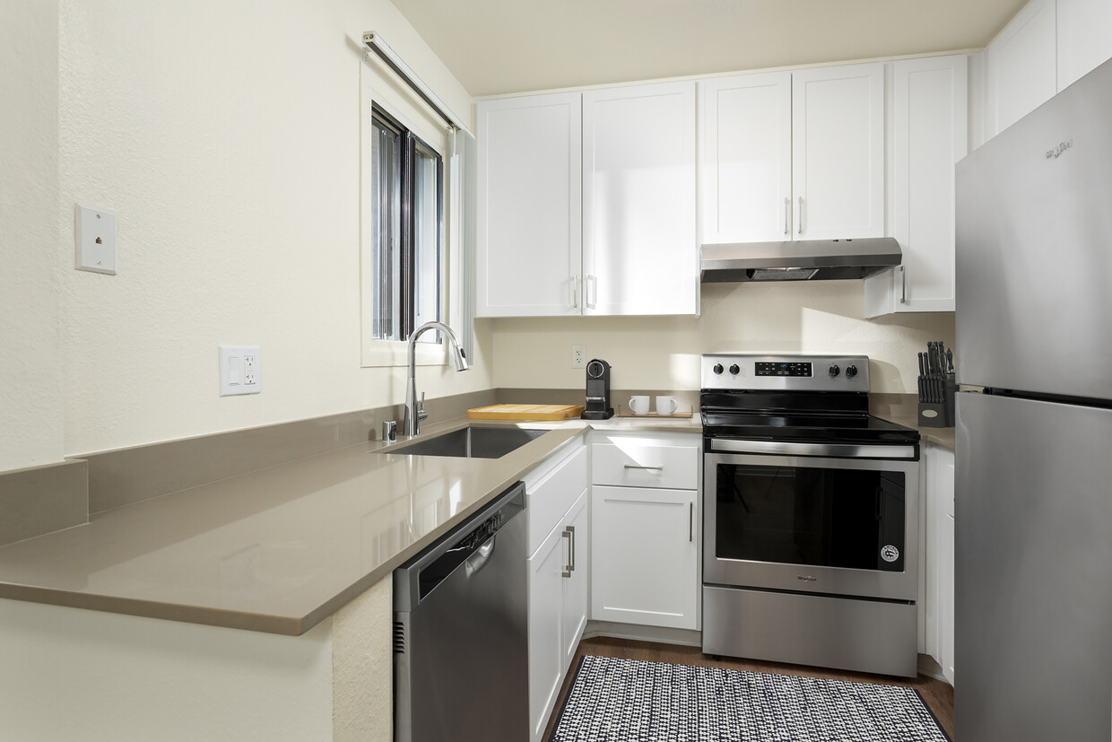 Cocina I renovada con encimeras de cuarzo gris, gabinetes blancos, electrodomésticos de acero inoxidable y pisos de superficie dura - eaves Warner Center