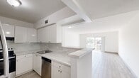 Located at 3800 Van Buren in Hollywood, FL, this one-bedroom, one-bathroom unit offers a clean, bright, and well-organized layout spread across a single floor. Light wood-look tile flooring runs throughout the entire space, creating a cohesive and modern aesthetic. The kitchen is a standout feature, equipped with crisp white cabinetry, marble-look countertops and backsplash, stainless steel appliances including a range and dishwasher, and a peninsula that opens to the living area — ideal for both cooking and casual dining. The open-concept living room is generously sized, filled with natural light, and anchored by sliding glass doors that lead out to a private balcony with outdoor views. The spacious primary bedroom features a large window allowing ample natural light and includes access to a dedicated closet. The bathroom is finished with marble-look tile on both the floors and tub surround, complemented by a single-sink vanity with a large mirror and a full-sized soaking tub with shower. Clean white walls and consistent finishes throughout give the entire unit a fresh, move-in-ready feel.