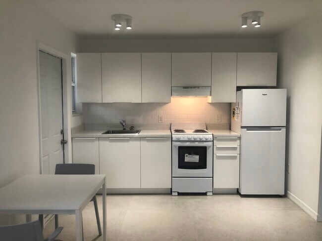 kitchen with ny subway tile and granite countertop - 5963 SW 66th Ter