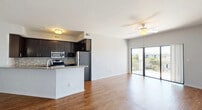 Located at Ballast Point Dr in Fort Myers, FL, this well-appointed 3-bedroom, 2-bathroom residence offers a thoughtfully designed single-floor layout. The open-concept living, dining, and kitchen area serves as the heart of the home, featuring warm wood-look flooring, neutral tones, and a ceiling fan that enhances the airy feel. Large sliding glass doors flood the space with natural light and open directly onto a private balcony with pleasant outdoor views. The kitchen is outfitted with dark espresso cabinetry, granite countertops, a mosaic tile backsplash, stainless steel appliances, and a breakfast bar peninsula ideal for casual dining. The three bedrooms are carpeted for comfort, each with closet access and ceiling fans. The primary bedroom includes its own en-suite bathroom featuring a glass-enclosed walk-in shower with decorative tile accents. The second bathroom offers a full tub-shower combo with matching tile detailing. A dedicated laundry area and six closets throughout provide ample storage. Hallways connect the rooms efficiently, completing this functional and comfortable Florida residence.