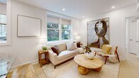 Located in the sought-after Kalorama neighborhood of Washington, DC, this thoughtfully designed one-bedroom, one-bathroom unit offers a clean, modern aesthetic throughout. The open-plan living and dining area is anchored by crisp white walls, light hardwood flooring, and recessed lighting that creates a bright, welcoming atmosphere. Large windows invite generous natural light and offer views of lush greenery, enhancing the airy feel of the space. The kitchen is outfitted with sleek, handle-free white cabinetry, white stone countertops, under-cabinet lighting, and stainless steel appliances, including a built-in oven, cooktop, and integrated refrigerator — a fully functional and visually cohesive culinary space. The bedroom is a calm retreat, featuring dual windows with garden views, light flooring, and direct access to a dedicated closet. The bathroom is finished with warm wood-toned tile surrounds, a glass-enclosed walk-in shower with a ceiling-mounted rainfall showerhead, and clean neutral tilework underfoot. A dedicated dining area connects seamlessly to the kitchen, completing this efficiently planned and well-appointed residence in one of DC's most desirable urban neighborhoods.