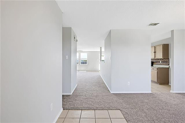 Front entry looking to living. Woodgrain tile in kitchen not pictured. - 1419 Windy Meadows Dr