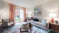 Located at 9412 Brightway Ct in Henrico, Virginia, this single-floor residence offers a well-organized layout designed for comfortable everyday living. The living room serves as the heart of the home, featuring hardwood-style flooring, crown molding, and a sliding glass door that opens to a private outdoor patio with views of a landscaped green area, allowing abundant natural light to fill the space. An accent wall adds a bold design touch, complementing the open, airy feel of the room.

The kitchen is outfitted with warm honey-toned cabinetry, dark granite-style countertops, and stainless steel appliances including a range, microwave, and refrigerator. Track lighting overhead and a window-lit dining nook adjacent to the kitchen create a bright and functional cooking and dining space.

The primary bedroom features plush carpeting, a natural light source through a window with decorative curtains, and ample room for furnishings. The second bedroom, accented with a sage green feature wall and soft carpeting, offers a calm and comfortable retreat. Both bathrooms include tub-shower combinations, warm wood-tone vanity cabinetry, and hardwood-style flooring, providing practical and well-appointed spaces throughout this inviting home.