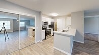 Located at 1355 Bradley Blvd in Savannah, GA, this two-story home offers a well-organized layout across two floors, with the majority of living space situated on the upper level. The kitchen is a standout feature, boasting white shaker cabinetry, stainless steel appliances including a range, microwave, and refrigerator, light quartz countertops, and a peninsula that opens to the adjacent living area. The light wood-style flooring on the main level provides a clean, cohesive look throughout the common areas. A carpeted staircase with a sturdy handrail connects the entry level to the upper floor, where both bedrooms are found. Each bedroom is finished with plush carpet, neutral gray-toned walls, and ceiling fans with integrated lighting. The generously sized primary bedroom includes its own closet, while the second bedroom is equally comfortable. Both bathrooms feature white vanity cabinetry, bright vanity lighting, and clean white finishes. One bathroom includes a tub-shower combination. The two closets provide practical storage throughout. The overall aesthetic is modern and neutral, creating a move-in-ready atmosphere suited for a variety of lifestyles.
