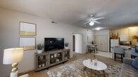 This single-floor residence in Springfield, Missouri offers a thoughtfully laid-out living space designed for comfortable everyday living. The open-concept living and dining area serves as the heart of the home, featuring neutral-toned carpet, tile flooring at the entry, a textured ceiling, and a ceiling fan with light fixture that keeps the space well-ventilated and bright. Natural light filters in through a window, creating a warm and inviting ambiance throughout. The living area flows naturally into a defined dining space, making it ideal for both relaxing and entertaining.

The kitchen is efficiently arranged with white cabinetry, a tile floor, laminate countertops, and a full suite of appliances including a refrigerator, electric range, microwave, and dishwasher. A peninsula counter provides additional workspace and casual dining potential.

The bedroom is a calm retreat featuring plush carpet, ample space for full bedroom furniture, and access to a closet. The bathroom is clean and functional, offering a single vanity with under-sink cabinetry, a large mirror with overhead lighting, and wood-look flooring that adds a touch of warmth. The overall aesthetic throughout the residence is neutral and understated, providing a versatile backdrop for a variety of interior styles.
