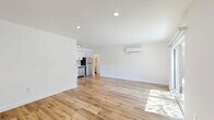 Located at 1185 Myra Ave in the heart of Los Angeles, this thoughtfully designed 2-bedroom, 2-bathroom single-story home offers a bright, modern living experience. The open-concept living and dining area serves as the heart of the home, featuring warm light wood flooring, crisp white walls, recessed lighting, and a wall-mounted mini-split system for year-round comfort. Sliding glass doors lead to a private patio, filling the space with abundant natural light. The kitchen is outfitted with white shaker cabinetry, stainless steel appliances, and clean countertops, with a tall pantry cabinet providing ample storage. Both bedrooms are well-proportioned and serene, with the primary bedroom offering a generous closet and its own mini-split unit. Each bedroom benefits from natural light through well-placed windows. The two bathrooms are finished in classic white subway tile with matte black fixtures, including a full soaking tub and overhead rain shower. Additional highlights include two closets, an in-unit laundry area with overhead cabinetry, and a connecting hallway that keeps the layout functional and cohesive. The overall aesthetic is clean, minimalist, and move-in ready.