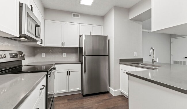 Select homes have upgraded kitchens with quartz countertops and wood flooring - Huntington Gateway