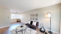 Located at 949 East St, Unit 406 in Lafayette, CA, this one-bedroom, one-bathroom unit offers a well-designed single-level layout that makes efficient use of its intimate footprint. The open-plan living and kitchen area forms the heart of the home, where light-toned hardwood-style flooring flows throughout. The living room is bright and airy, featuring a large sliding glass door that invites natural light and provides outdoor access, complemented by neutral gray-green walls that lend a calm, cohesive atmosphere. A ceiling fan overhead adds both function and style. The galley-style kitchen is thoughtfully appointed with white shaker cabinetry, dark quartz countertops, a stainless steel sink, and stainless steel appliances including a full-size refrigerator and dishwasher. Ample upper and lower cabinet storage makes the kitchen highly functional. The bedroom offers a cozy retreat with plush wall-to-wall carpeting and a wide window framing views of surrounding greenery, creating a peaceful, nature-connected feel. The full bathroom is cleanly finished with white cabinetry, a dark quartz vanity top, an undermount sink with brushed nickel fixtures, and a tub-shower combination with a window for natural ventilation. Every room reflects a clean, updated aesthetic throughout.