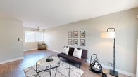 Located at 949 East St, Unit 406 in Lafayette, CA, this one-bedroom, one-bathroom unit offers a well-designed single-level layout that makes efficient use of its intimate footprint. The open-plan living and kitchen area forms the heart of the home, where light-toned hardwood-style flooring flows throughout. The living room is bright and airy, featuring a large sliding glass door that invites natural light and provides outdoor access, complemented by neutral gray-green walls that lend a calm, cohesive atmosphere. A ceiling fan overhead adds both function and style. The galley-style kitchen is thoughtfully appointed with white shaker cabinetry, dark quartz countertops, a stainless steel sink, and stainless steel appliances including a full-size refrigerator and dishwasher. Ample upper and lower cabinet storage makes the kitchen highly functional. The bedroom offers a cozy retreat with plush wall-to-wall carpeting and a wide window framing views of surrounding greenery, creating a peaceful, nature-connected feel. The full bathroom is cleanly finished with white cabinetry, a dark quartz vanity top, an undermount sink with brushed nickel fixtures, and a tub-shower combination with a window for natural ventilation. Every room reflects a clean, updated aesthetic throughout.