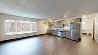 Located at 1820 Ethan Way in Sacramento, CA, this one-bedroom, one-bathroom unit offers a practical and functional layout across a single floor. The open-concept living and kitchen area forms the heart of the space, finished with durable wood-style flooring throughout and a textured ceiling overhead. A large window with vertical blinds fills the living area with natural light, creating a bright and inviting atmosphere.

The kitchen is well-appointed with a full suite of stainless steel appliances, including a refrigerator, electric range with oven, and dishwasher. Grey-toned cabinetry with granite-style countertops provides ample storage and prep space, complemented by recessed lighting above. A wall-mounted A/C unit serves the main living area.

The bedroom is a comfortable, carpeted retreat featuring a wide window with outdoor views and a full-width sliding closet that offers generous storage. The bathroom is equipped with a full bathtub and shower combination, complete with accessibility grab bars and a handheld showerhead, making it both practical and inclusive.

Throughout the unit, clean neutral walls, dark baseboards, and consistent flooring create a cohesive and understated aesthetic well-suited for easy, comfortable living.