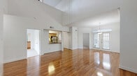 Located at 14885 Memorial Dr in Houston, TX, this 3-bedroom, 1-bathroom multi-story home offers a thoughtfully designed layout spread across three floors. Gleaming hardwood floors flow throughout the main level, enhancing the bright and airy living areas. The living room is bathed in natural light from large windows and French doors that open to an outdoor balcony view, creating a seamless indoor-outdoor connection. A pendant light fixture adds a touch of elegance to the open dining area.

The kitchen is well-equipped with light maple cabinetry, granite countertops, a tile backsplash, and a full suite of stainless steel appliances, including a gas range, built-in microwave, dishwasher, and refrigerator. A closet with louvered bi-fold doors provides additional storage just off the kitchen.

The three bedrooms are carpeted for comfort, each featuring ceiling fans and crown molding. The generously sized primary suite on the upper floor includes access to a walk-in closet and a full bathroom, while a second spacious walk-in closet offers ample storage. The bathroom is clean and functional, featuring a combined tub and shower with full tile surround, hardwood flooring, and a vanity with granite countertops.