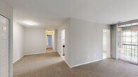 Located at 3900 Blackburn Ln, Unit 44, in Burtonsville, MD, this single-floor, 2-bedroom, 2-bathroom residence offers a well-organized layout designed for comfortable everyday living. The galley-style kitchen is a functional highlight, featuring white shaker cabinetry, granite-look countertops, a stainless steel gas range with overhead ventilation hood, a stainless steel refrigerator, and a built-in sink — all set over light wood-look flooring. Adjacent to the kitchen is a bright dining area with light wood-look floors, natural light from windows with vertical blinds, and a seamless connection to the main living space. The spacious living room is carpeted and opens to a private balcony through large floor-to-ceiling sliding glass doors, offering pleasant outdoor views of the surrounding greenery. Both bedrooms are generously sized and carpeted, each featuring windows with blinds that allow natural light to fill the rooms. The primary bedroom provides a comfortable and quiet retreat. The two bathrooms are finished with clean white tile surrounds in the tub/shower combinations, offering a crisp and functional design. A hallway and closet round out the layout, providing practical storage and easy flow throughout the unit.