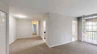 Located at 3900 Blackburn Ln, Unit 44, in Burtonsville, MD, this single-floor, 2-bedroom, 2-bathroom residence offers a well-organized layout designed for comfortable everyday living. The galley-style kitchen is a functional highlight, featuring white shaker cabinetry, granite-look countertops, a stainless steel gas range with overhead ventilation hood, a stainless steel refrigerator, and a built-in sink — all set over light wood-look flooring. Adjacent to the kitchen is a bright dining area with light wood-look floors, natural light from windows with vertical blinds, and a seamless connection to the main living space. The spacious living room is carpeted and opens to a private balcony through large floor-to-ceiling sliding glass doors, offering pleasant outdoor views of the surrounding greenery. Both bedrooms are generously sized and carpeted, each featuring windows with blinds that allow natural light to fill the rooms. The primary bedroom provides a comfortable and quiet retreat. The two bathrooms are finished with clean white tile surrounds in the tub/shower combinations, offering a crisp and functional design. A hallway and closet round out the layout, providing practical storage and easy flow throughout the unit.