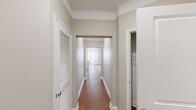 This 1,330 sq ft single-floor apartment at 2701 Watermark Blvd, Apt 1332, Oklahoma City, OK offers four bedrooms, two bathrooms, and a thoughtfully designed layout. The open-concept kitchen and living area serves as the heart of the home, featuring wood-look flooring, crown molding, a large center island with a white quartz countertop, pendant lighting, stainless steel appliances, and light wood cabinetry. Multiple windows flood the space with natural light. The four bedrooms include plush carpeting and ceiling fans; secondary bedrooms feature natural light from exterior windows, while the primary bedroom spans 160 sq ft. Three closets provide ample storage, including a spacious walk-in with wire shelving systems. The two bathrooms offer wood-look tile flooring and light wood vanities with white countertops. The primary bath includes direct closet access, while the secondary bath features a full tub-shower combo. A dedicated laundry room with side-by-side washer and dryer hookups adds everyday convenience. Neutral tones, clean white trim, and consistent finishes throughout create a cohesive, modern aesthetic across the entire unit.