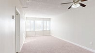 Located at 726 Washington St in Reading, PA, this one-bedroom, one-bathroom unit offers a thoughtfully laid-out single-floor plan with a comfortable sense of space. The living room is generously proportioned, featuring wall-to-wall carpeting, a ceiling fan with light fixture, and a bank of large windows fitted with blinds that invite abundant natural light while providing views of the surrounding cityscape. The tile drop ceiling adds a distinctive character to the space. The kitchen is outfitted with white shaker-style cabinetry, marble-look countertops, wood-look vinyl flooring, and a full-size refrigerator, offering a clean and functional cooking area. The bedroom is a comfortable retreat with soft carpeting, a ceiling fan, a closet with double doors, and windows that frame outdoor views. With six closets throughout the unit, storage is plentiful. The bathroom features a tiled tub-shower combination, a toilet, wood-look vinyl flooring, and a vanity with countertop space. The neutral color palette and bright, open feel throughout the unit create a calm and practical living environment well-suited for everyday comfort.