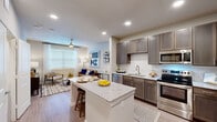 Located at 22103 Gosling Road in Spring, TX, this one-bedroom residence offers a thoughtfully designed single-level floor plan that maximizes functionality and comfort. The open-concept layout seamlessly connects the kitchen and living room, creating an inviting and cohesive living space.

The kitchen is a standout feature, showcasing rich dark-toned cabinetry, a white subway tile backsplash, and a full suite of stainless steel appliances, including a French door refrigerator, dishwasher, microwave, and range. A central granite-topped island with bar seating serves as both a prep area and casual dining space, making it ideal for entertaining.

The living room is bright and welcoming, benefiting from large windows that allow generous natural light to fill the room. A ceiling fan adds to the comfort of the space, which features light wood-style flooring that runs throughout the main areas.

The bedroom is a comfortable retreat with its own ceiling fan, large window, and direct access to an en-suite bathroom. A dedicated closet provides ample storage. The room's neutral color palette and clean finishes create a calm and restful ambiance.

Overall, this residence combines modern finishes with a practical layout, offering a comfortable and stylish living experience in Spring, TX.