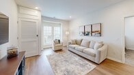 Located at 2500 Kelly Rd in Warrington, PA, this well-appointed 2-bedroom, 2-bathroom residence offers a clean, modern aesthetic throughout its single-floor layout. The open-concept kitchen and living area serves as the heart of the home, featuring light wood-tone cabinetry paired with crisp white upper cabinets, white quartz countertops, and a full suite of stainless steel appliances including a refrigerator, range, and microwave. Durable light wood-tone flooring flows through the kitchen and living areas, adding warmth to the contemporary design. The living room is bright and welcoming, highlighted by large windows that invite natural light and offer outdoor views, complemented by recessed lighting and rich hardwood-style flooring. Both bedrooms feature plush carpet, ceiling fans, and ample natural light, with the primary bedroom offering a generous walk-in closet and direct access to its own bathroom. Each bathroom is finished with a floating wood vanity, a large mirror, white quartz countertops, and a glass-enclosed shower adorned with elegant marble-style tile. Additional closet storage is available throughout the unit, ensuring practical functionality. The overall ambiance is clean, bright, and contemporary, making this a well-designed and comfortable residence.