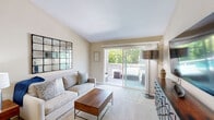 Located at Bay Village Circle in Santa Rosa, CA, this well-designed one-bedroom, one-bathroom residence offers a comfortable and functional layout across its single main level. The living room serves as the heart of the home, featuring vaulted ceilings, soft carpeting, and large sliding glass doors that flood the space with natural light and provide direct access to a private outdoor deck. The deck offers a relaxing retreat with views of mature trees and the surrounding neighborhood. The open-concept flow connects the living area to the combined dining room and kitchen, where hardwood-style flooring, a pass-through counter, and stainless steel appliances create a practical yet inviting space. The dedicated dining nook features a ceiling fan and natural light from a nearby window, making it ideal for everyday meals. The bedroom is a well-proportioned retreat with plush carpeting, a closet, and easy access to the hallway and bathroom. The bathroom is cleanly finished with a wide vanity, white countertop, a large framed mirror, and warm-toned cabinetry. A notable convenience is the in-unit stacked washer and dryer, adding everyday practicality. Throughout, the warm neutral palette and thoughtful layout make this a well-rounded and efficiently designed residence.