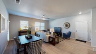 Located in Colorado Springs, CO, this single-floor residence offers a thoughtfully designed, open-concept layout that seamlessly connects the living, dining, and kitchen areas. The main living space features light hardwood-style flooring, neutral wall tones, a ceiling fan, and multiple windows fitted with blinds that invite generous natural light. A defined dining area flows effortlessly into the comfortable living room, which provides ample space for both relaxing and entertaining.

The kitchen is a standout feature, showcasing rich dark cabinetry, granite countertops, stainless steel appliances, recessed lighting, and a peninsula with bar seating — ideal for casual dining or meal prep. A versatile secondary room serves as a dedicated home office or flex space, complete with carpet flooring, natural light, and enough room for a desk and seating area.

The bedrooms are carpeted and well-lit with large windows, each offering a calm, comfortable atmosphere. One bedroom includes views to the exterior, adding a sense of openness. The bathroom is finished with dark wood cabinetry, granite countertops, a tub-shower combination, and light hardwood-style tile flooring, maintaining a consistent, cohesive aesthetic throughout the home.