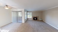Located at 2395 Caringa Way in Carlsbad, CA, this single-story home offers a well-designed layout with comfortable living spaces throughout. The living room serves as the focal point of the home, featuring plush neutral carpeting, crown molding, and a tile-surround fireplace with a raised hearth. Natural light fills the room through multiple windows with blinds, while a ceiling fan adds functionality. Vertical sliding glass doors provide access to the outdoors, bringing in views of the surrounding greenery.

The kitchen is outfitted with white cabinetry, dark speckled countertops, a double stainless steel sink, and a window overlooking the outdoors. Wood flooring grounds the space, adding warmth and contrast to the light cabinetry.

The bedrooms are carpeted and feature recessed bay-style windows, ideal as built-in seating areas with garden views. Mirrored sliding closet doors enhance the sense of space and reflect natural light throughout.

The bathroom includes a vanity with dark countertops, a large mirror, wood flooring, and a full tub-shower combination, providing a clean and functional design. Overall, the home presents a bright, cohesive interior in a desirable Carlsbad location.