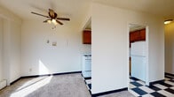 Located at 2233 N Summit Ave in Milwaukee's vibrant East Side neighborhood, this single-floor unit offers a well-organized layout designed for comfortable everyday living. The spacious living area features soft carpeting, a ceiling fan with light fixture, and an open sightline into the kitchen, creating a connected and airy feel. Large windows throughout the unit flood the interior with natural light and frame views of the surrounding Milwaukee cityscape and treetops.

The kitchen is equipped with warm-toned wood cabinetry, white appliances including a range and dishwasher, a stainless steel sink, and a bold black-and-white checkered tile floor that adds a classic, retro character to the space. Upper cabinets provide ample storage along the full length of the kitchen wall.

The bedrooms are carpeted and well-lit, each featuring wide windows with blinds and baseboard heating units positioned beneath the sills. The rooms offer a clean, neutral palette suited for a variety of furnishing styles.

Two bathrooms serve the unit, each with its own distinct character. One features yellow tile accents, a white vanity with under-sink storage, and a large mirror, while the second showcases mint-green tiled walls surrounding a full tub and shower, a light-toned vanity, and tile flooring — both reflecting a mid-century aesthetic throughout.