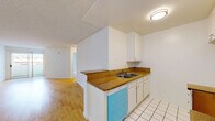 Located at 515 S Harvard Blvd in the heart of Los Angeles, this one-bedroom, one-bathroom unit offers a practical and well-organized layout across a single floor. The open living room is a welcoming space featuring warm hardwood flooring and bright white walls that reflect natural light, creating an airy atmosphere. A textured ceiling adds a classic touch throughout the common areas. The galley-style kitchen is thoughtfully designed with white cabinetry, granite-toned countertops, a double-basin sink, white tile flooring, and a dishwasher, with a peninsula that opens toward the living area for easy flow between spaces. Two closets provide ample storage throughout the unit. The bedroom offers plush wall-to-wall carpeting, a sliding closet, a window with natural light, and direct access to the full bathroom. The bathroom is finished with white tile flooring, a granite-topped vanity, a large wall mirror, and a tub-shower combination enclosed by sliding glass doors. A private balcony extends the living space outdoors. This unit combines functional design with comfortable living in a central Los Angeles location.