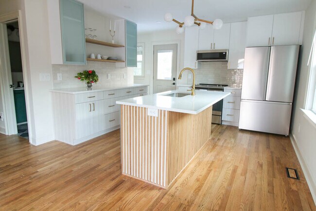 Lots of kitchen storage with modern brass accents. - 2406 Boswell Rd