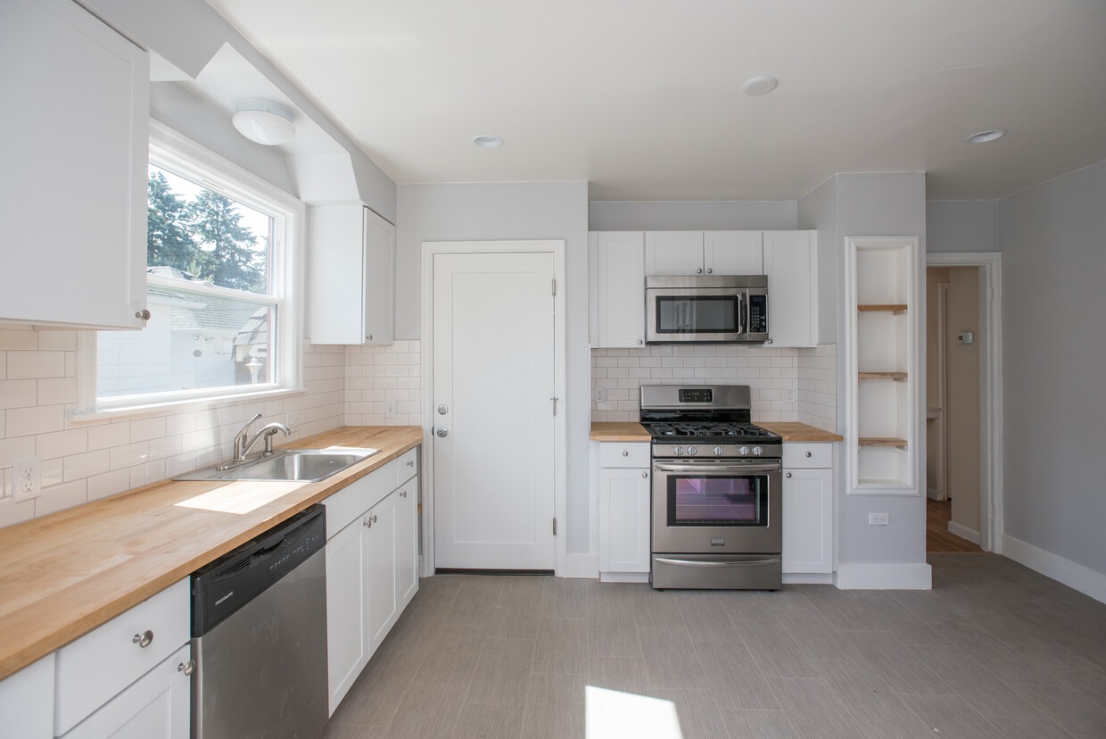 New counter tops and new cabinets. Tons of kitchen storage. - 2628 Northeast Ainsworth Street