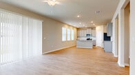 Located at 1528 Diane St in Spring Hill, FL, this two-story home offers four bedrooms and five bathrooms across a well-designed layout. The main floor sets a welcoming tone with light hardwood-style flooring, neutral warm-toned walls, and recessed lighting throughout. The open-concept living and kitchen area is a central highlight, where the kitchen impresses with gray shaker-style cabinetry, granite countertops, a center island, subway tile backsplash, and stainless steel appliances, all flowing seamlessly into the living space complete with a ceiling fan. Structural columns and wide hallways add architectural character to the first floor. The attached garage is spacious and includes an automatic opener and an electrical panel. The upper floor houses the bedrooms, including a generously sized primary suite with a ceiling fan, multiple windows for natural light, and access to a walk-in closet with built-in wire shelving. Additional bedrooms are bright and well-proportioned, each with blinds and ample natural light. A dedicated laundry room on the upper floor features a washer/dryer hookup, a drain pan, and overhead shelving. The five bathrooms are cleanly finished, and three closets throughout the home provide excellent storage capacity.