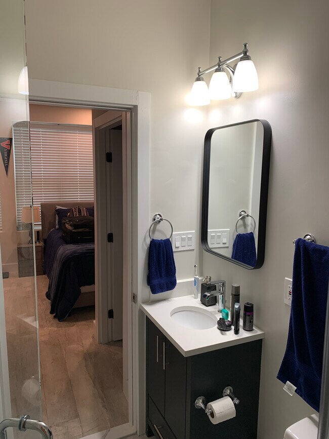 Bathroom sick and hallway to bedroom. - 2556 University Pl NW