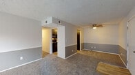 Located at 249 E Reynolds Rd in Lexington, Kentucky, this single-floor unit offers a well-organized layout designed for comfortable everyday living. The living area is generously sized, finished with plush carpet and a ceiling fan, and features a two-tone gray wall treatment with a chair rail detail that carries throughout the common spaces. Natural light filters in through a set of French doors that open to an outdoor patio, enhancing the open feel of the room. A ceiling fan provides additional comfort overhead.

The kitchen is a standout space, showcasing bold dark cabinetry paired with clean white countertops and wood-look flooring. It is fully equipped with black appliances, including a refrigerator, electric range, built-in microwave, and dishwasher, along with ample upper and lower cabinet storage.

The unit includes multiple bedrooms, each carpeted and featuring natural light from individual windows with blinds and textured ceilings. The rooms offer a neutral palette, providing versatility for a variety of furnishing arrangements.

Two full bathrooms serve the unit, each featuring wood-look flooring, a vanity with dark cabinetry, a toilet, and a tub-shower combination with clean white surrounds. The overall design is practical and cohesive, with consistent finishes throughout the space.