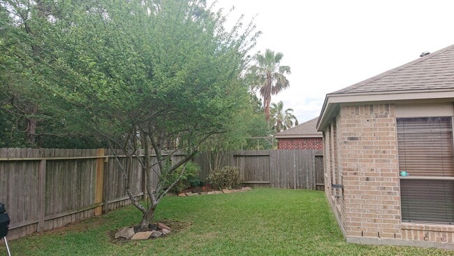 Backyard with a sprinkler system. - 7414 Lakesage Lane