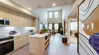 Located at 101 Chamomile Glen in Escondido, CA, this two-story, 2-bedroom, 2-bathroom home offers a thoughtfully designed layout spread across two floors. The expansive main floor anchors the home with an open-concept living, dining, and kitchen area. The kitchen is outfitted with light wood cabinetry, stainless steel appliances, a white tile backsplash, and a central island with open shelving and quartz countertops — ideal for both cooking and entertaining. The living room impresses with soaring double-height ceilings and large windows that flood the space with natural light, creating an airy, inviting ambiance. Hardwood-style flooring runs throughout the main level, complementing the contemporary aesthetic. The primary bedroom is generously proportioned, featuring plush carpet, a bold accent wall, a ceiling fan, and a dedicated walk-in closet. The second bedroom is bright and comfortable, with natural light streaming in through large windows. Both bathrooms are well-appointed, one featuring a full tub/shower combination with striking dark tile surround. A dedicated laundry area adds everyday convenience. The upper floor provides additional private living space, completing this well-rounded home.