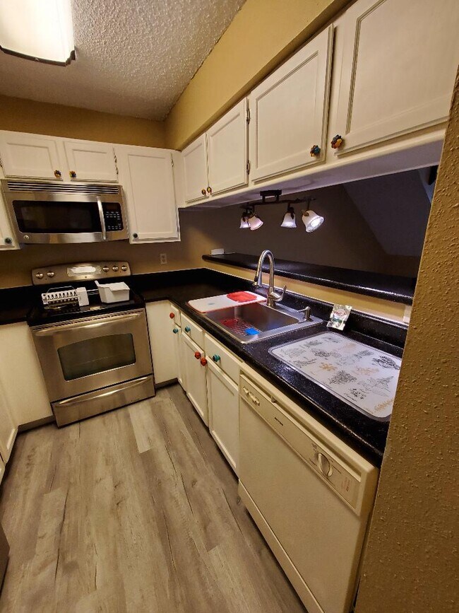 Kitchen has all amenities lighted by spotlight over the bar - 4107 Medical Dr