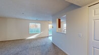 Located in Grandville, Michigan, this single-story, one-bedroom, one-bathroom unit offers a thoughtfully designed layout that maximizes comfort and functionality. The combined kitchen and living room serves as the heart of the home, where plush carpeting flows throughout the living area while wood-look vinyl flooring grounds the kitchen. Multiple windows invite generous natural light, brightening the open space and offering pleasant outdoor views. The kitchen is well-equipped with warm oak cabinetry, stainless steel appliances including a refrigerator, electric range, and over-the-range microwave, along with a stainless steel sink and ample counter space. A pass-through window connects the kitchen to the living area, enhancing the open feel. A sliding glass door provides direct access to the outdoors. The bedroom is a comfortable retreat featuring two separate closets — one with a bi-fold door and one with a hinged door — providing exceptional storage capacity. Multiple windows fill the bedroom with natural light. The bathroom includes a full tub/shower combination with grab bars, wood-look vinyl flooring, and a vanity with oak cabinetry. Textured ceilings add character throughout the unit, completing this practical and inviting home.